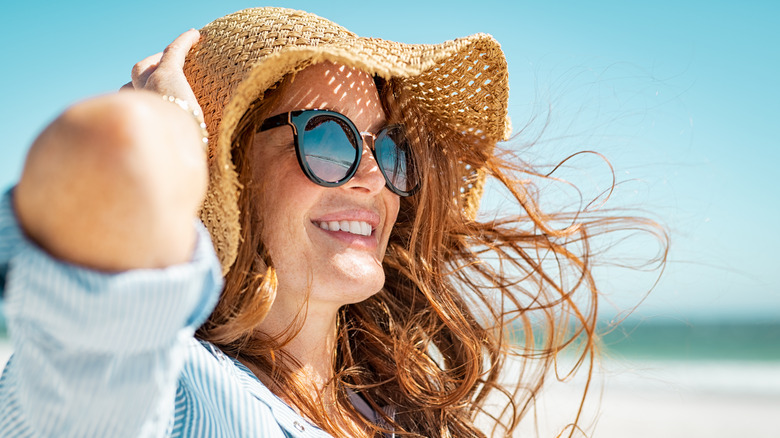 Woman wearing hat and sunglasses