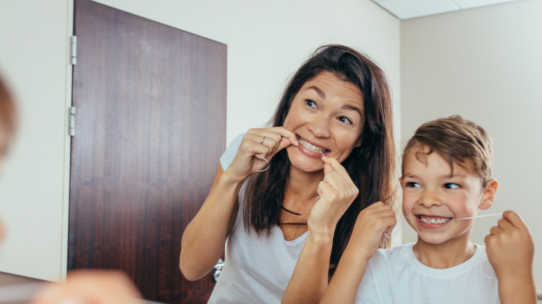 A woman and child flossing