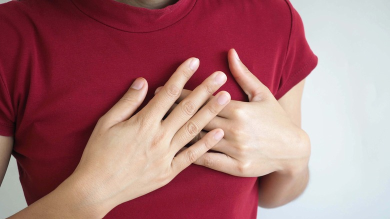 A woman clutches her chest