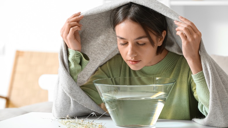 woman inhaling steam to clear congestion