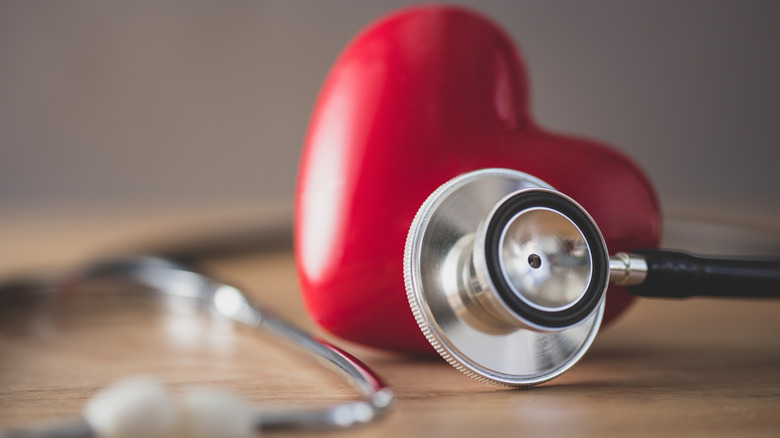 Stethoscope next to heart model