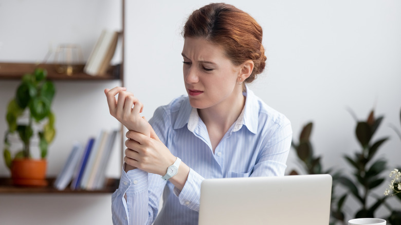 Woman holding her wrist in pain