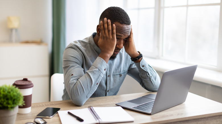 A man is stressed at his desk