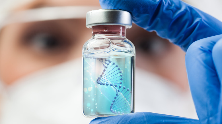 scientist holding vial with dna