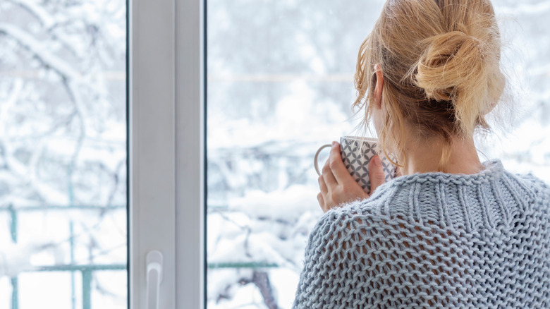 woman looking out at snow