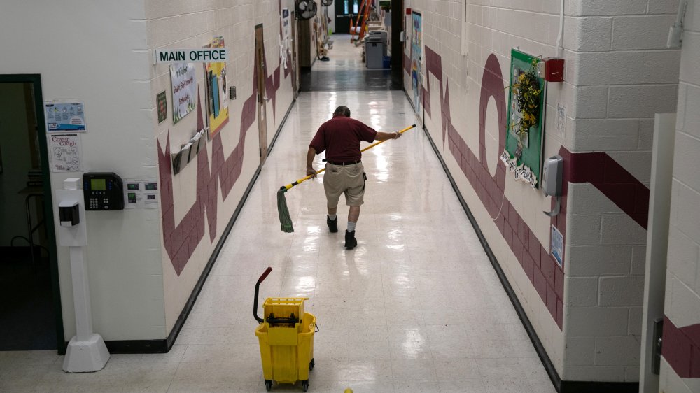 Custodian cleaning school