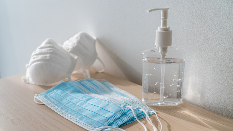 set of COVID masks and hand sanitizer on a table