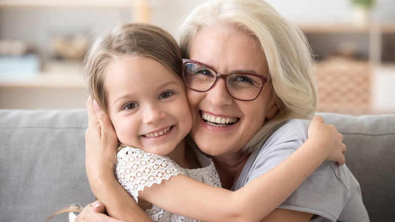 Vaccinated grandparent hugging grandchild