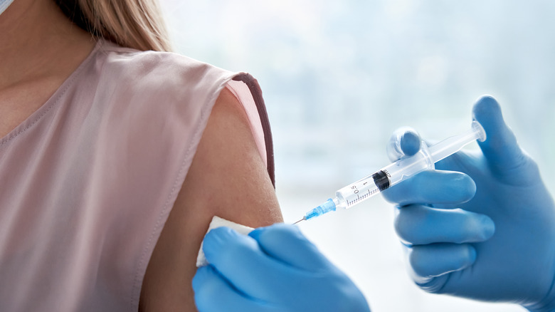 woman's arm receiving vaccination