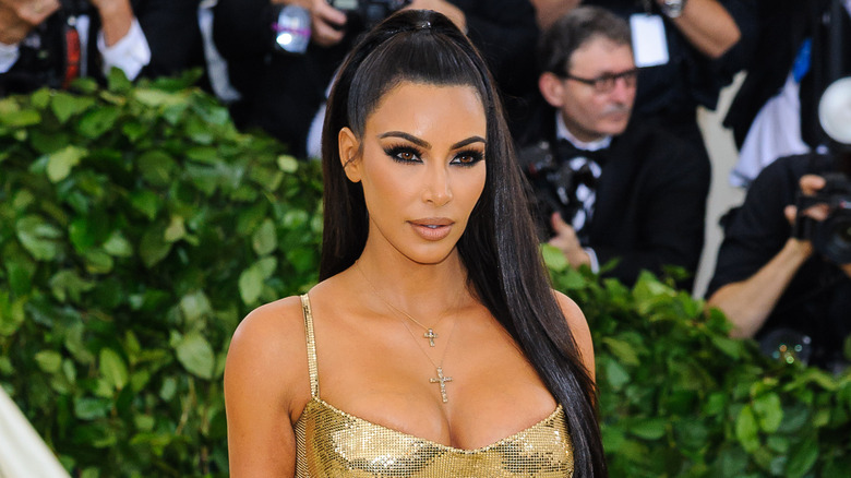 Kim Kardashian in a gold sequined gown