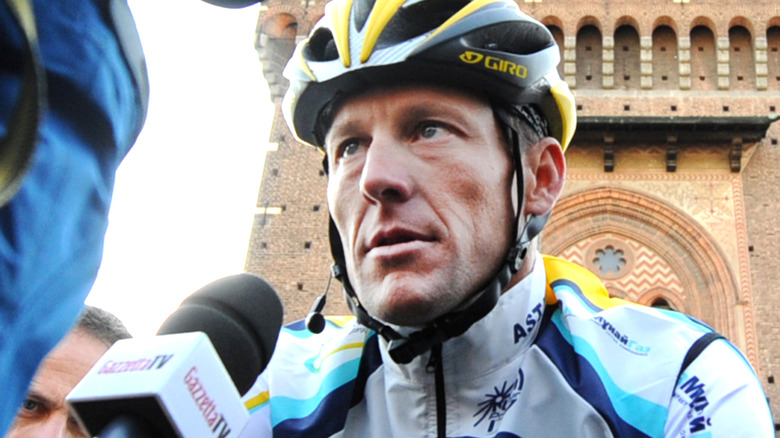 Lance Armstrong in bike helmet being interviewed 
