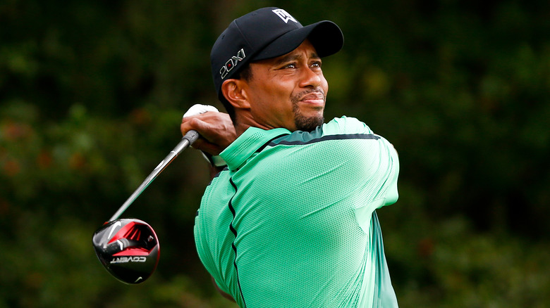 Tiger Woods in a hat with a golf club.