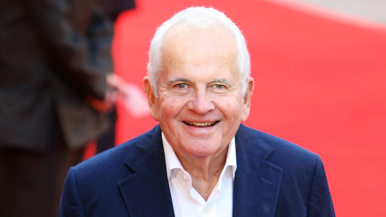 Ian Holm smiling on red carpet