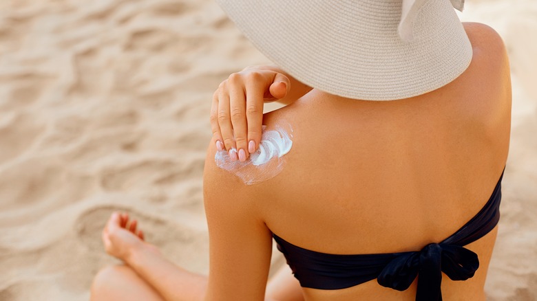 Woman applying sunscreen