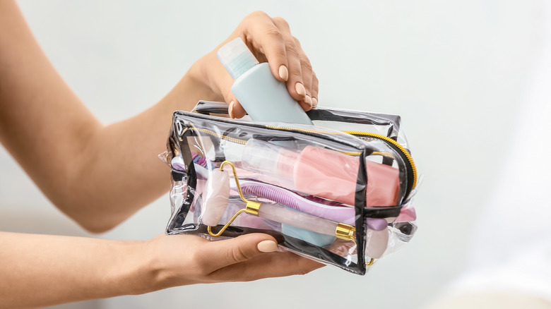 Woman packing a toiletry bag