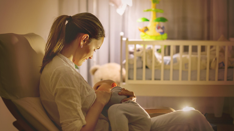 mother breastfeeding her baby in recliner 