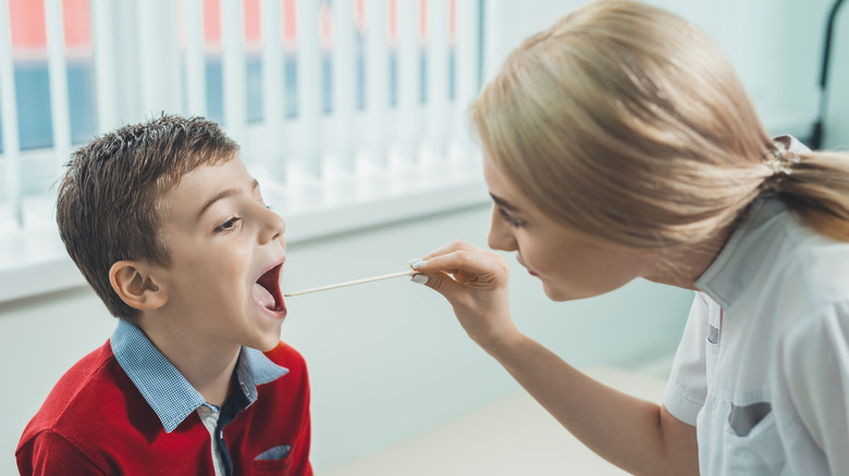 boy with strep throat being examined