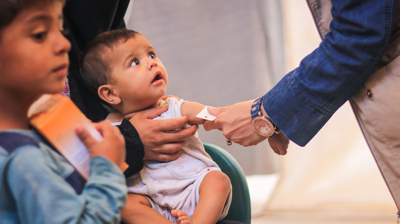 doctor examining malnutrition in child