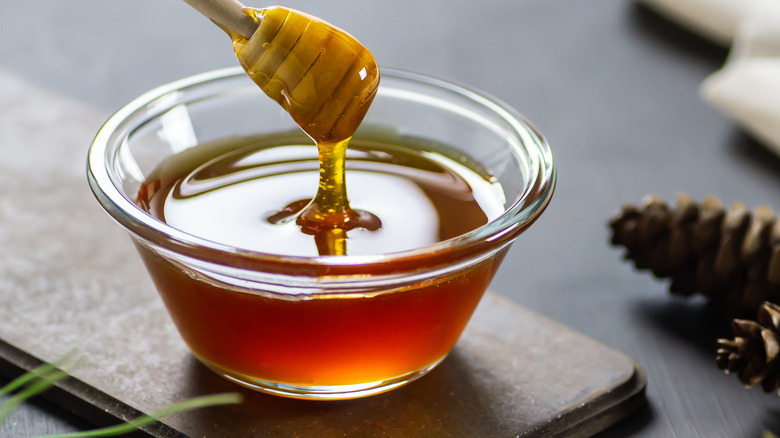 honey in bowl with honey stick