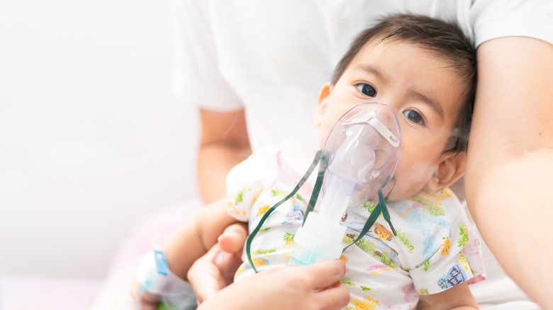 Baby given a nebulizer for lung problem