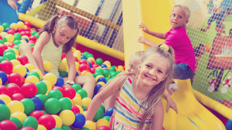 young children playing in a ball pit