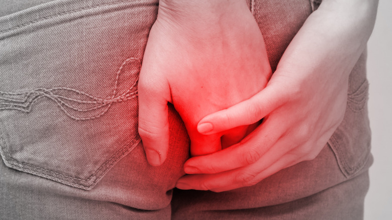 woman in jeans hands covering butt 