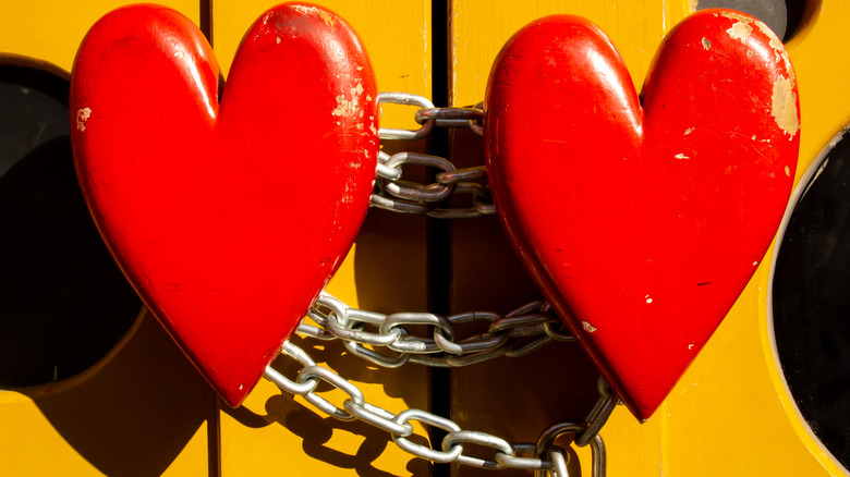 hearts held together by lock and chain