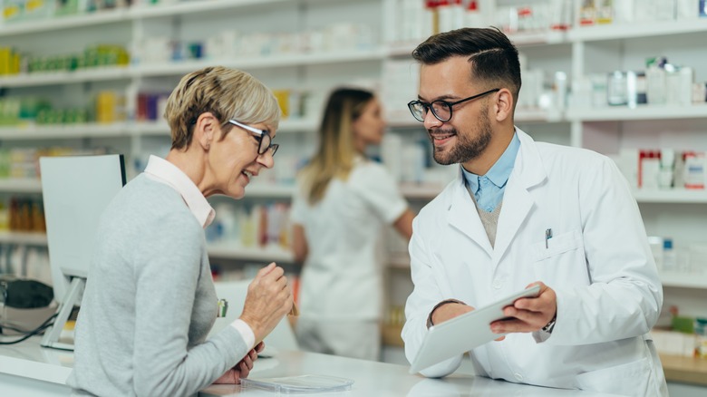 Pharmacist speaking to customer