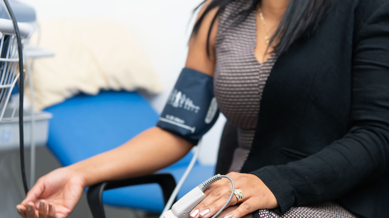 Woman with blood pressure cuff