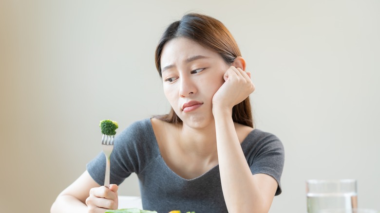 Woman looking at food uninterested