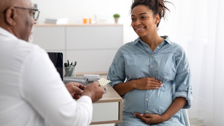 doctor talking to pregnant woman