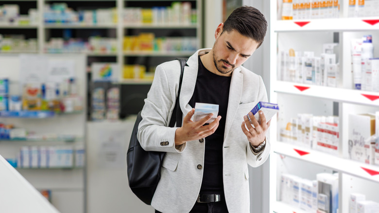 Pharmacy shopper looking at two boxes