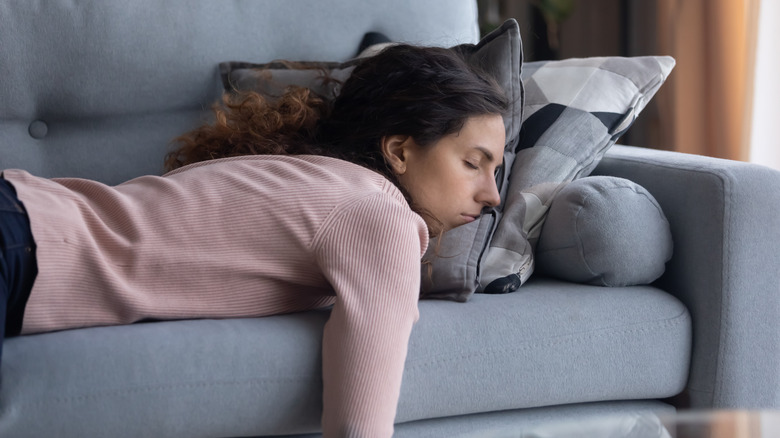 Woman lying on her stomach on the couch