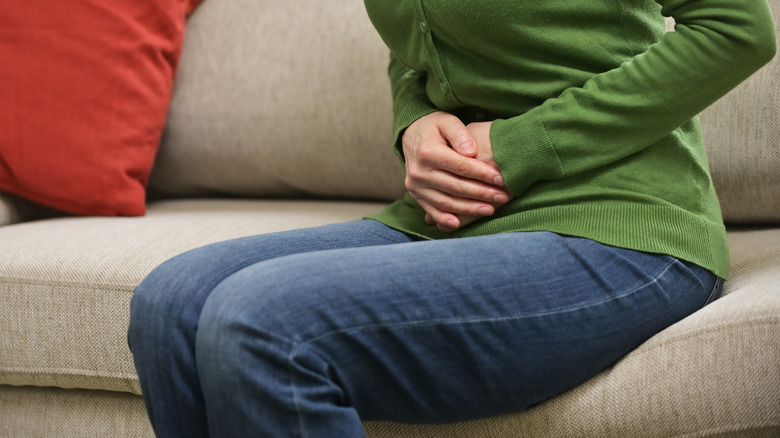 A woman holding her abdomen