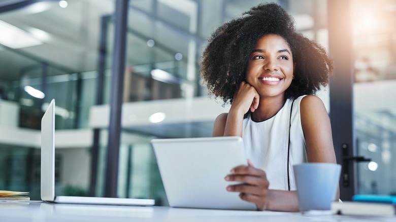 woman sitting at desk with coffee