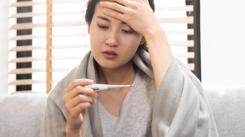 Woman checking her temperature