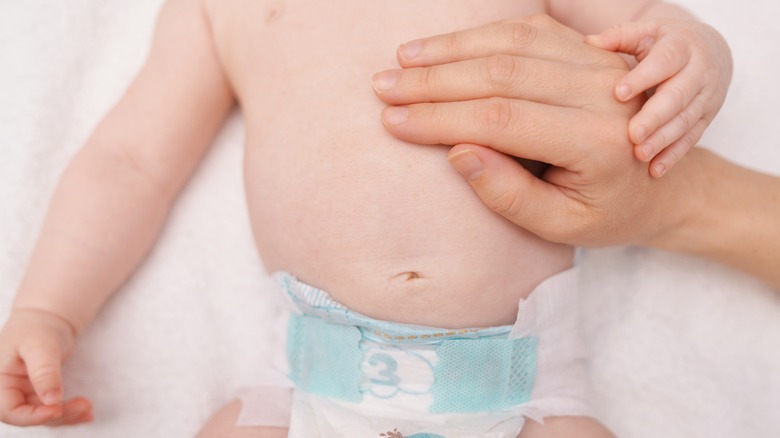 mom's hand on baby's stomach