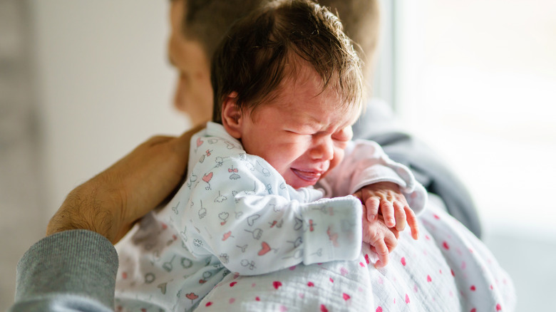 father burping colicky baby