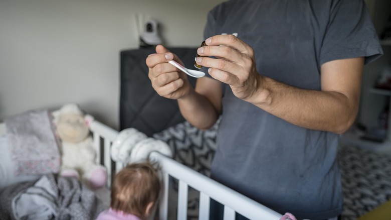 dad giving probiotics to baby