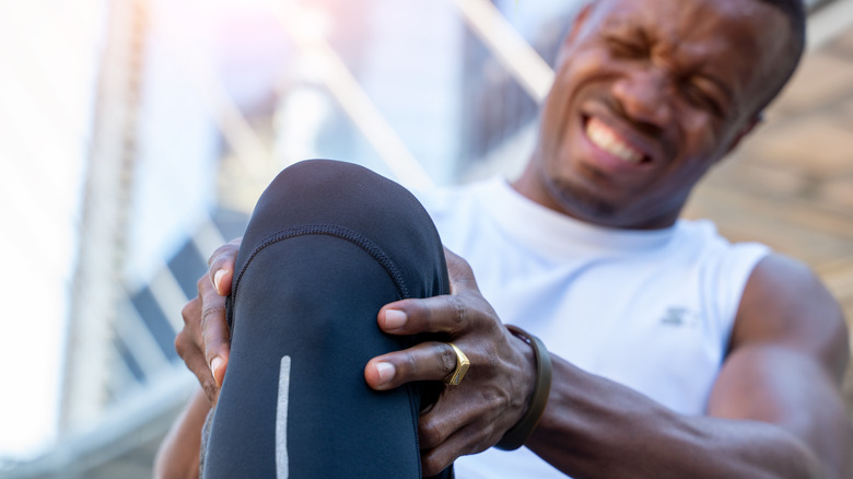 Runner holding his leg in pain