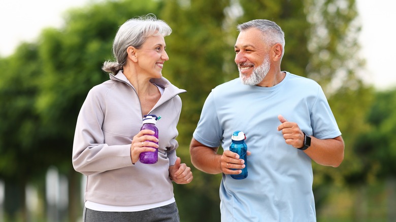 Retirees jogging outside in city park