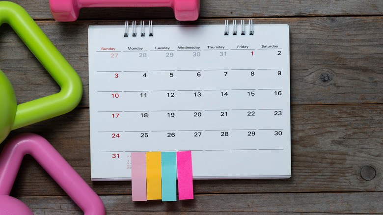 Calendar and sport equipment on table