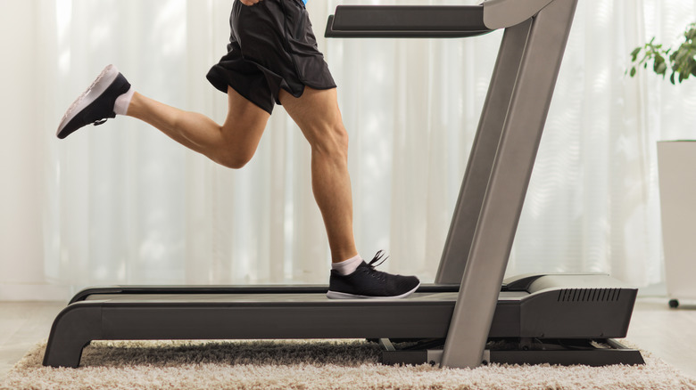 Man exercising on a treadmill at home