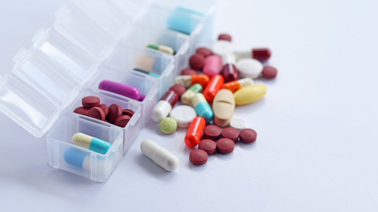 pill box with assorted medication spilling out