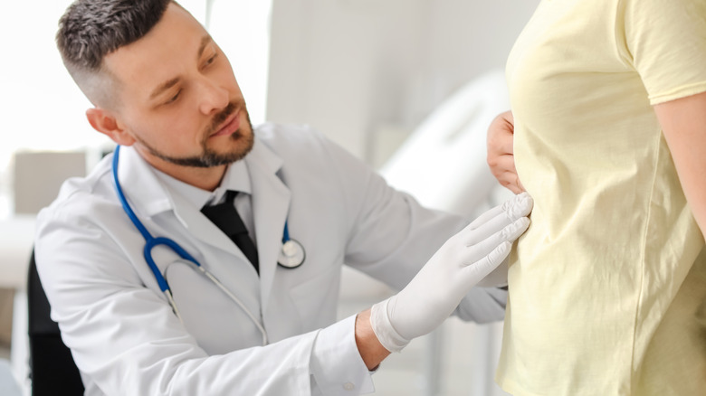 doctor examining patient with peptic ulcer