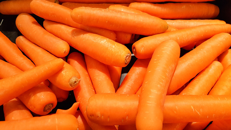 A bunch of whole carrots piled on top of one another
