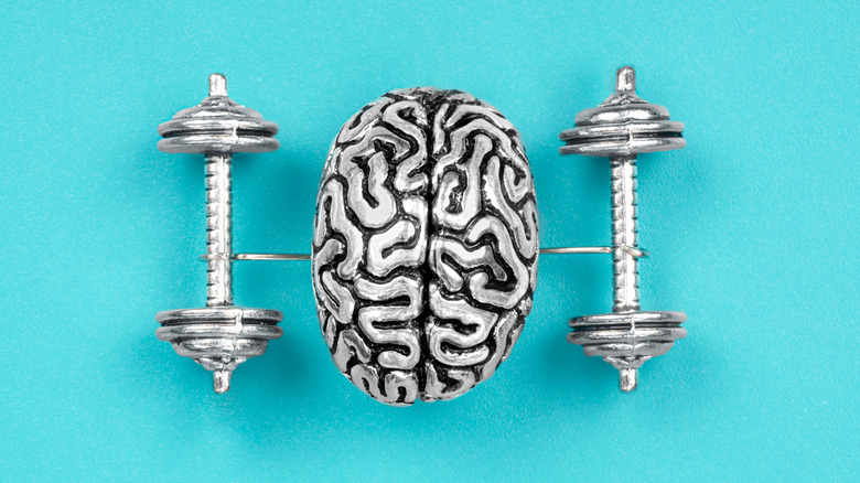 A metal brain with two appendages holding two dumbbells