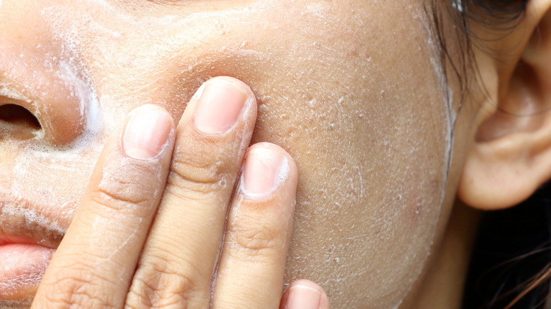 closeup of woman exfoliating skin