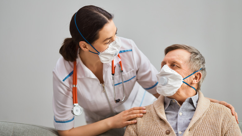 doctor with mask talking with man in mask