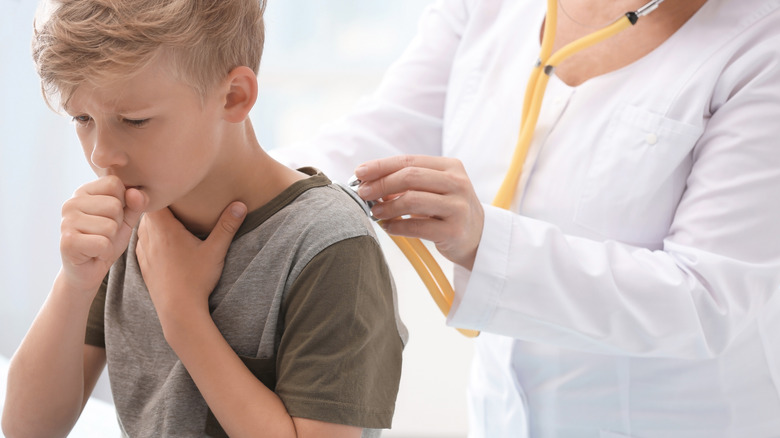 doctor checking child's cough